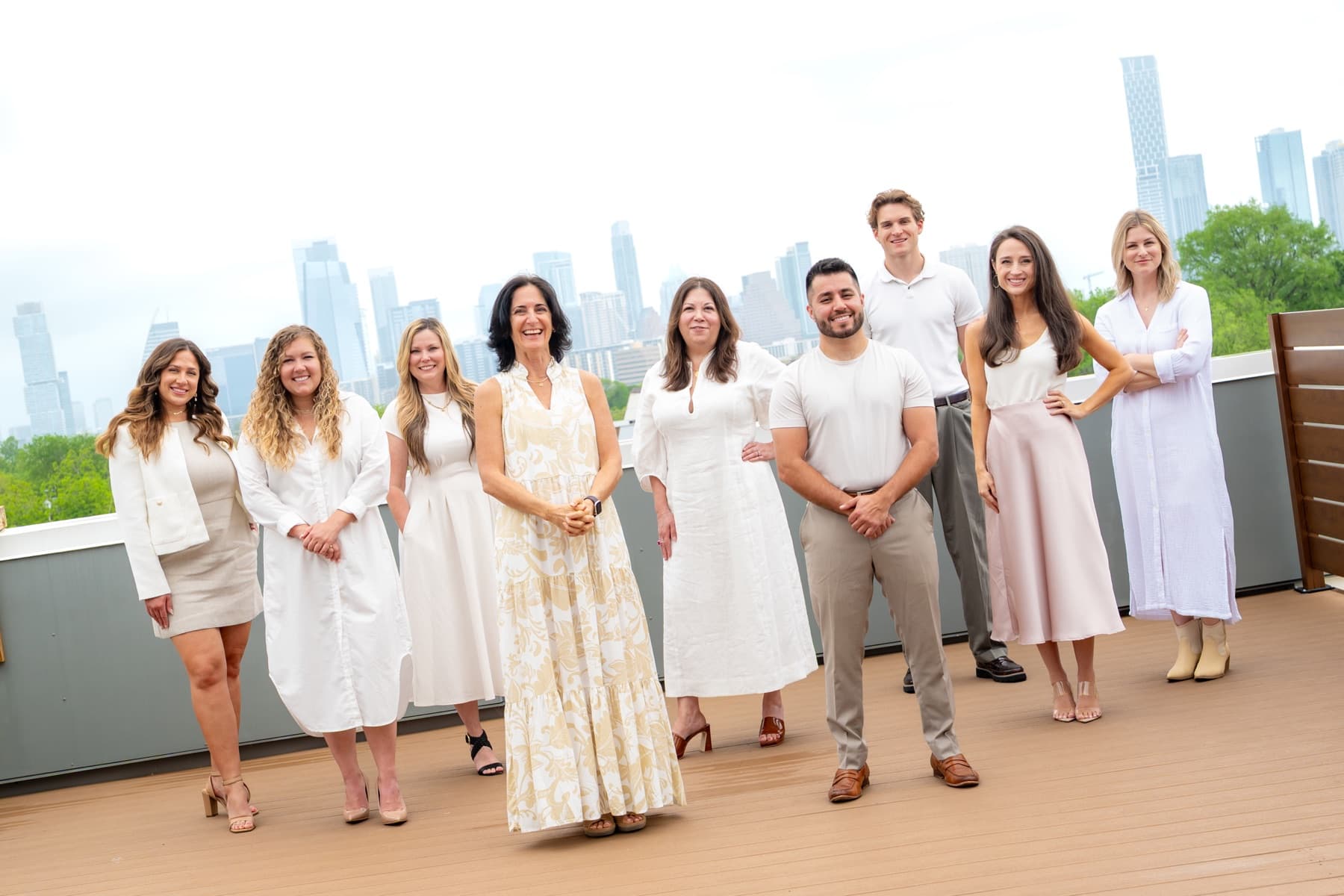 The team on a rooftop with the downtown Austin skyline behind them